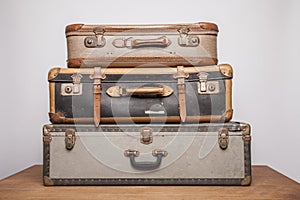 Old, retro, suitcases lie on the table with white background