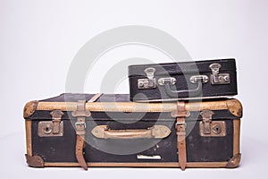 Old, retro, suitcases lie on the table with white background