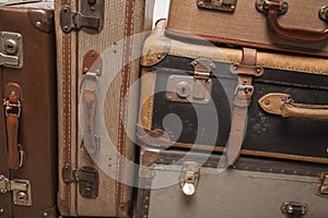 Old, retro, suitcases lie on the table with white background