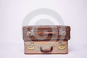 Old, retro, suitcases lie on the table with white background