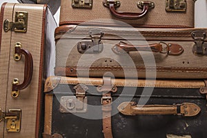 Old, retro, suitcases lie on the table with white background