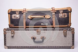 Old, retro, suitcases lie on the table with white background