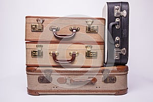 Old, retro, suitcases lie on the table with white background