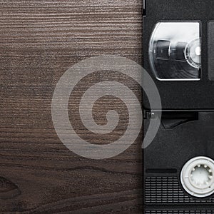 Old retro video tapes over wooden background