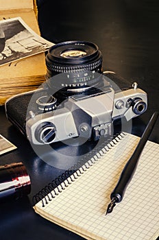 Old retro vintage camera and notebook with fountain pen