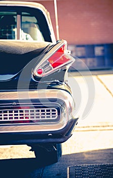 Old retro vintage classic black chromed car park at petrol station in Woking UK.