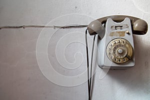 Old retro vintage rotary analogic telephone on a white background.