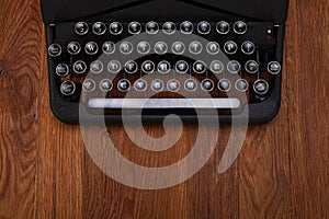 Old retro vintage typewriter on wooden board