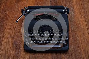Old retro vintage typewriter on wooden board