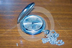 Old retro watch on the table,  an old silver handy watch, antique pocket watch, old silver pocket watch