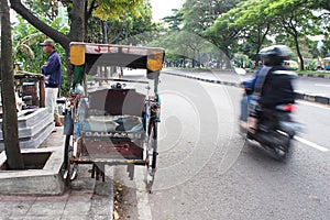 an old rickshaw parked on the side of the highway