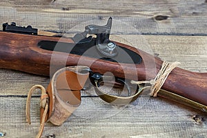 Old rifle gun with a trigger close-up on a wooden table