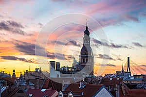 Old Riga roofs and Saint Peters Church on sunset