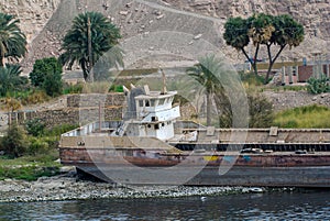 Old river barge abandoned on the shore for scrapping on the Nile river,