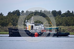 Old river tug, and the installation of river beacons