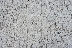 Old road background surface of grey cracked asphalt texture