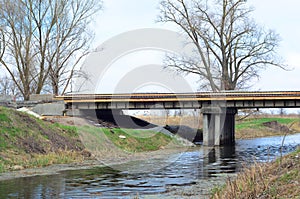 An old road bridge reconstruction and repair. A road bridge repair, resurfacing, improvement and reconstruction with small spans