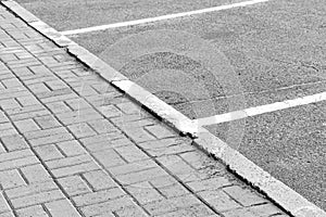 Old road markings on the asphalt. Erased white diagonal stripes. Grey asphalt