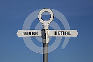 Old road sign with work and retire pointing in opposite directions