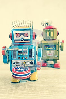 Old robot toy on wood table, vintage color style.