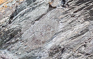 Old rock carvings of an ancient man on rocks in Siberia.