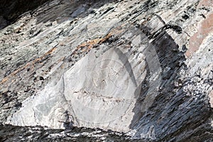 Old rock carvings of an ancient man on rocks in Siberia.
