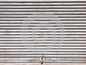 The old rolling shutters are dirty and rusting.