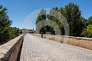 Old Roman bridge leading away from Salamanca in Spain