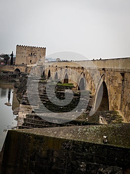 an old roman bridge over Guadalquivir river photo