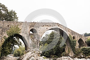 Old Roman stone bridge in Cangas de Onis over the river in Spain