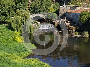 Old Roman stone bridge and waterfall on Este River in Vila do Conde, Portugal