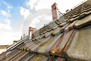 Old roof with roofing tiles and chimneys