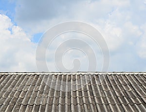 Old roof tile pattern over sky