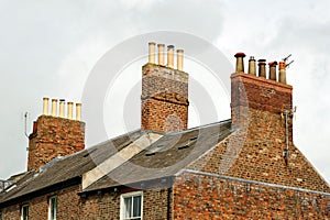 Old roof top with chimney pots on an English house. UK