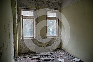 Old room with broken windows at the abandoned building in the Chernobyl ghost town