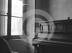 Old room with a piano in black and white