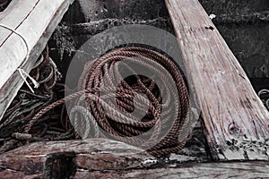 An old rope at the bottom of a fishing boat.  Everything is ready to go to sea.  Fishing schooner equipment