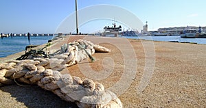 Old rope lying on the ground in fishing dock, slow zoom