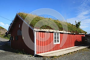 Old rorbu with grass on the roof in Sund