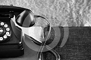 Old rotary phone on table