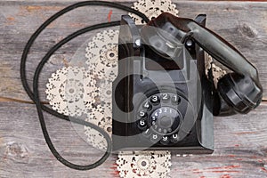 Old rotary telephone with the handset off the hook