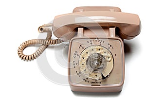 Old rotary telephone on white