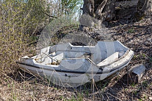 Old rotten paddle boat in the bushes