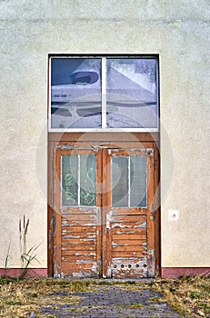 Old rotten wooden front door with peeling paint