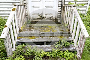 Old rotting covered stairs on a building