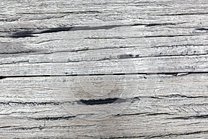 Old rough gray wooden planks full of cracks