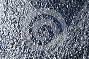 Old rough surface of a concrete wall with an uneven coating