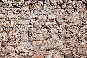 Old rough uneven brown stone wall background