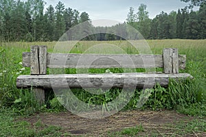Old rough wooden country bench, front view, concept of privacy, silence, tranquility, pacification,  inherit parental home photo
