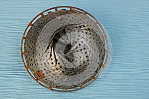 Old round iron ware on a blue table